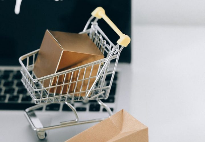 a miniature shopping cart on macbook laptop
