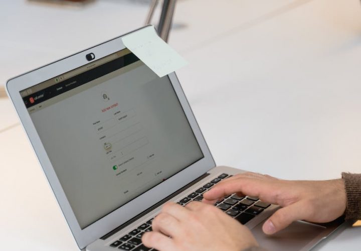 hands typing on laptop keyboard